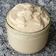 a jar filled with cream sitting on top of a counter