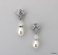 These cubic zirconia earrings have sparkling marquise paired with Austrian peals.  These dangle earrings are the perfect addition to your wedding gown and special occasion attire.   They can be dressed up or down. Perfect for any elegant bride! They measure 1 3/8" long from top to bottom.  Width is approximately 1/2"  teardrop earls measure 11x8mm. **Please note champagne refers to powder almond look at the color chart.** **If your dress is ivory I recommend the white color in my opinion it is an off white and works with white and ivory gowns.  The cream works with cream, light cream and some champagne shades.  If you need help deciding the color pearl that works best for you.  Please send me a picture of your dress and I am happy to help** Original design Divine Jewel © All Rights Reserve Teardrop Pearl Earrings, Earrings Bride, Ivory Gown, Elegant Bride, Wedding Bridal Jewellery, Bride Gift, Cubic Zirconia Earrings, Zirconia Earrings, Light Cream