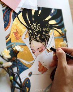 a person is painting an image on paper