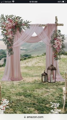 an outdoor wedding setup with pink drapes and flowers