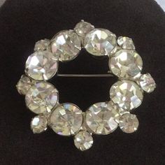 "Featuring this lovely and sparkly clear rhinestone circle brooch. It has a silver tone setting and measures 2\" diameter. The brooch is in very good vintage condition." Dichroic Pendant, Dichroic Glass, Clear Rhinestones, Etsy Vintage, Brooch Pin, Brooches, Topaz, Silver Tone, Gold Tones