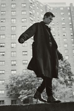 black and white photograph of a man walking in the city