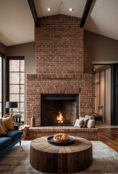 a living room filled with furniture and a fire place in the middle of a room