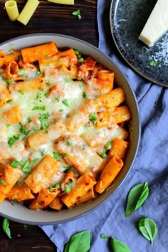 a bowl filled with pasta and cheese on top of a table