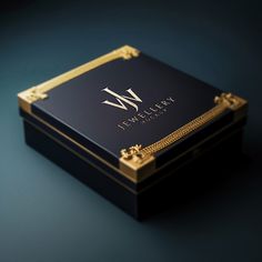 a black and gold business card case with the letter m on it's side