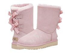 UGG Bailey Bow II Shimmer - Women's Shoes : Pink Cloud : Keep warm and look good in the UGG Bailey Bow II Shimmer mid-calf boot; crafted from a metallic suede upper topped with a satin bows at back for added appeal. Features a round toe and polyester bindings. Offers 17mm of cozy UGGplush made from 80% wool and 20% lyocell. New Treadlite by UGG outsole provides increased traction, durability, cushioning and flexibility. Imported. Measurements: Heel Height: 1 1 4 in Circumference: 14 in Shaft: 6 Womens Pink Uggs, Pink Uggs With Bows, Feminine Esthetics, Expensive Outfits, Pink Ugg Boots, Cute Uggs, Uggs With Bows, Ugg Bailey Bow, Uggs Boots