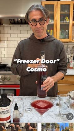 a man standing in front of a counter filled with liquid