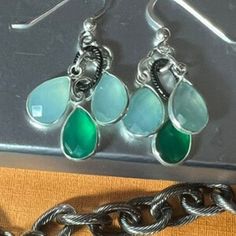 Welcome Spring and Summer!  Brighten up your wardrobe with aqua chalcedony and green onyx gems that pop out against bright sterling silver, and darkened brass.  Approx 5x7mm faceted pear gems, for a length of 1.5 inches.  Hook earrings. Check out the matching bracelet!  Available for immediate shipment. Faceted Silver Chalcedony Jewelry, Luxury Chalcedony Earrings For Women, Chalcedony Natural Stone Drop Earrings, Green Chalcedony Pendant Jewelry, Elegant Nickel-free Chalcedony Jewelry, Aqua Chalcedony, Onyx Earrings, Green Onyx, Matching Bracelets