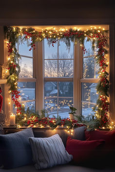 a living room decorated for christmas with lights and garland on the window sill,