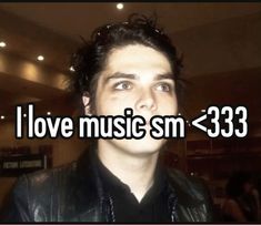 a man wearing a leather jacket with the words i love music sm > 33 in front of him