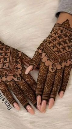 the hands are decorated with henna designs