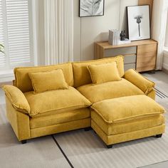 a yellow sectional sofa in a living room