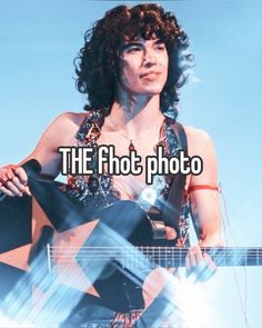 a woman holding a guitar in her right hand and the words, the shot photo