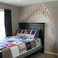 a bedroom with a baseball themed bed spread