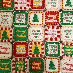 many decorated christmas cookies are arranged on a table