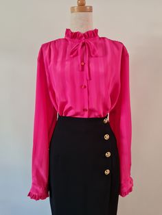 Right On by Remona Melbourne, Fuschia pink self stripe long sleeved jacquard blouse with ruffles at neckline and cuff. Button through with button cuff and simple rouleau mock bow at neckline.  She's marked a fabulous plus size 20, but see measurements below to check on actual sizing (closer to an 18). Fuschia Pink  100% Polyester Very Good Condition Body Length from HPS -  71cm  Sleeve length from CB Neck - 79cm   Shoulder width - 45cm  Bust - 62cm  Hip - 62cm Follow us on Instagram @packratt_vi Elegant Long Sleeve Pink Blouse, Elegant Pink Long Sleeve Blouse, Chic Pink Formal Blouse, Chic Long Sleeve Pink Blouse, Chic Pink Long Sleeve Blouse, Pink Formal Blouse For Fall, Formal Pink Blouse For Fall, Elegant Pink Tie Neck Top, Pink Ruffled Tops For Formal Occasions