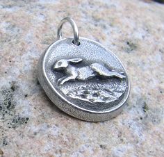 Running Rabbit Pendant or Bunny Charm. Size is 3/4 of an inch. Hand cast in fine pewter. Oxidized and polished finish. *If you need cording or chain to go along with this item. Please see this section of my shop: https://www.etsy.com/shop/KDemARTe?section_id=5443896 **Please check my shop policies before ordering to see important information on turnaround times, shipping methods and returns : http://www.etsy.com/shop/KDemARTe/policy?ref=shopinfo_policies_leftnav Running Rabbit, Bunny Jewelry, Rabbit Jewelry, Rabbit Earrings, Rabbit Necklaces, Rabbit Pendant, Spring Bunny, Jewelry Hand, Rustic Jewelry