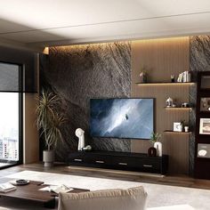 a living room with a large flat screen tv on top of a wooden entertainment center