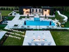 an aerial view of a backyard with a swimming pool and lounge chairs in the foreground