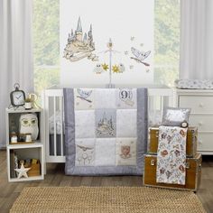 a baby crib bedding set with castle and stars on the wall in front of it