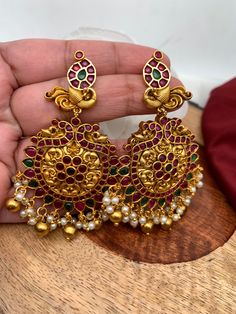 Goddess Lakshmi Floral Red Green Stone Nakshi Long Necklace with Matching EarringsColor : GoldenSize : Necklace Length : 24 Inches; Earring Length : 3 inches; Earring Weight : 15 grams EachStones : Red Green Stone Pearls