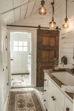 a bathroom with white walls and wooden doors