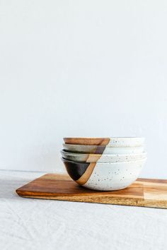 four white and brown bowls stacked on top of each other