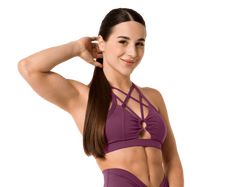 a woman with long hair wearing a purple sports bra