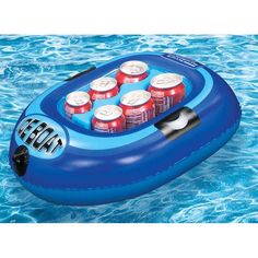 an inflatable cooler floating on top of a pool with six cans of soda