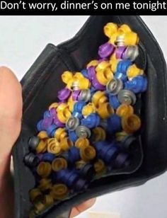 a person is holding a bag full of buttons with the caption don't worry, dinner's on me tonight