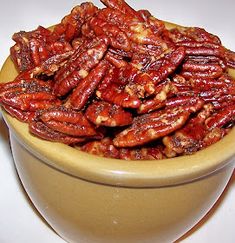 a bowl full of pecans sitting on top of a table