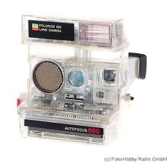 an old fashioned camera in a clear plastic case on a white background with the words auto focus 600 printed on it