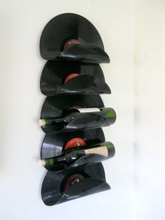 a wall mounted record player with wine bottles in it's casings and the number one on each side