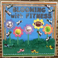 a bulletin board with flowers, grass and sports balls in the center that says blooming with fitness