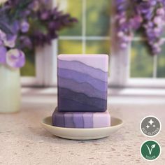 purple marble blocks sitting on top of a white plate