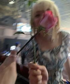 a woman with a fake rose in her mouth