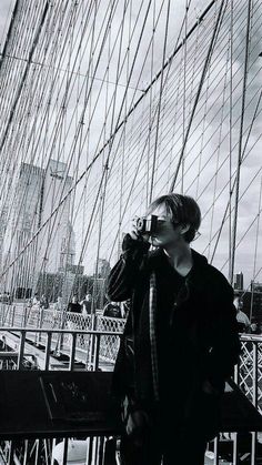 a man standing on top of a bridge next to a tall building