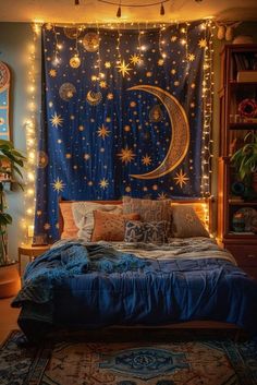 a bedroom decorated in blue and gold with lights strung from the ceiling over the bed