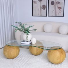 a living room with white couches and glass tables