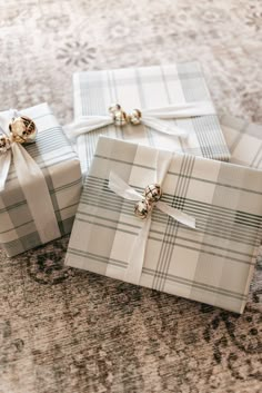 two wrapped presents sitting on top of a rug