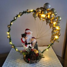 a santa clause is sitting on a table with christmas decorations