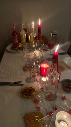 a table is set with candles and food