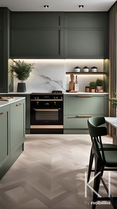 a modern kitchen with green cabinets and marble counter tops, along with an island in the middle