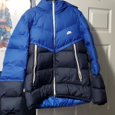 Brand New Nike Jacket. Never Worn. No Rips No Stains. Blue Hooded Sport Coat For Outdoor, Navy Hooded Outerwear For Spring, Outdoor Blue Down Puffer Jacket, Blue Hooded Outerwear For Fall, Blue Sporty Hooded Jacket For Cold Weather, Blue Down Puffer Jacket For Streetwear, Blue Puffer Jacket With Pockets For Outdoor, Blue Nylon Hooded Jacket With Pockets, Sporty Blue Hooded Jacket For Cold Weather