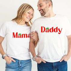 a man and woman standing next to each other wearing matching shirts that say mama, daddy