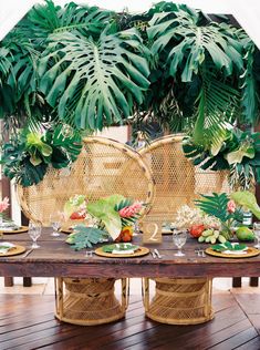 the table is set with plates and place settings for an outdoor dinner or brunch party