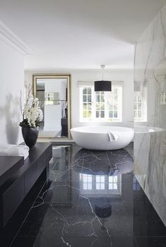 a large bathroom with marble floors and walls