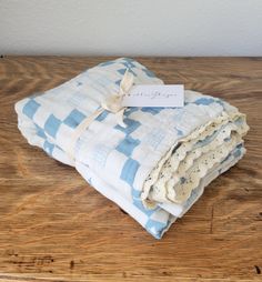 folded blue and white checkered blanket on wooden table