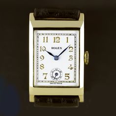 An Art Deco vintage wristwatch by Rolex dated 1938. Yellow gold 9ct case marked Rolex and "RWC LTD” for the Rolex Watch Company Ltd and "31 Records Universels” (World’s Records), Geneva, Suisse. Hallmarked for Glasgow import into the United Kingdom in 1938. Snap back. 15-Rubies (Jewels), Rolex, rectangular Ultra Prima HW movement. . Ultra Prima was the highest grade Rolex movement of the day. Silvered dial with raised gold stylised Art Deco Arabic numerals, an indented subsidiary dial for second Classic Collectible Watch With Rectangular Dial, Vintage Yellow Gold Watch With Rectangular Dial, Classic Watches With Rectangular Dial For Collectors, Classic Collectible Watches With Diamond Hour Markers, Vintage Yellow Gold Watch With Date Display, Vintage Yellow Gold Watches With Date Display, Classic Yellow Gold Watch Accessories With Date Display, Vintage Yellow Gold Watch Accessories With Date Display, Vintage Watch Accessory With Date Display