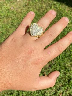 Gorgeous men's or ladies iced heart shaped ring
SOLID 925 sterling silver bonded with real 14k yellow goldStamped 925Will never tarnish or turn your hand green! Gold lasts many years as its bonded to real silver underneathRing is set with man simulated diamonds all around band
So icy you will look like you came from outer space
 
These aren't cheap cubic zirconia and look exactly like real diamonds!Ring is 14-15 grams depending on size!Nice large size about 25x25mm (slightly les Yellow Gold Iced Out Jewelry Ring, Iced Out Gold Rings For Gift, Gold Heart Ring With Pave Setting, Gold Jewelry With Pave Setting For Valentine's Day, Gold Heart Cut Ring With Pave Setting, Gold Heart Cut Rings With Pave Setting, Gold Heart Ring With Vvs Clarity, Heart-shaped 14k Gold Jewelry With Pave Setting, Heart Cut Jewelry With Pave Setting For Promise